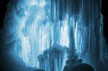 Huge Ice Icicles. Large Blocks Of Ice Frozen Waterfall Or Water. Blue Ice Background. Frozen Stream Waterfall
