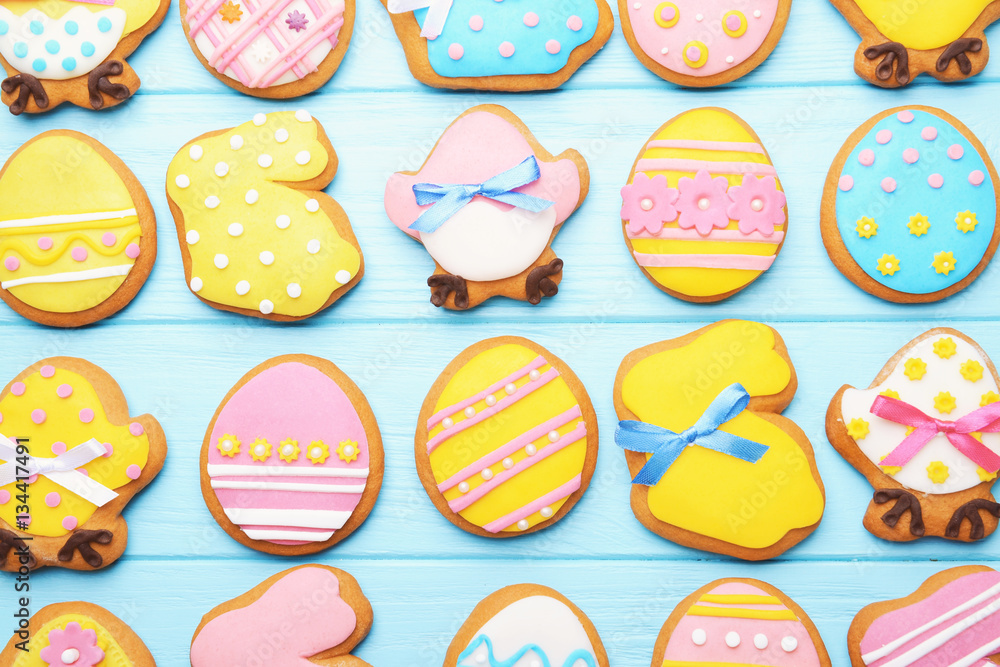 Decorative gingerbread Easter cookies on blue wooden background