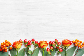 Sticker - Hypericum, roses and rowan on white wooden background