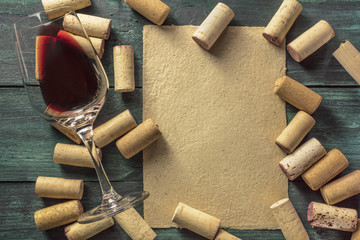 Wall Mural - Red wine glass, corks, and parchment with copyspace