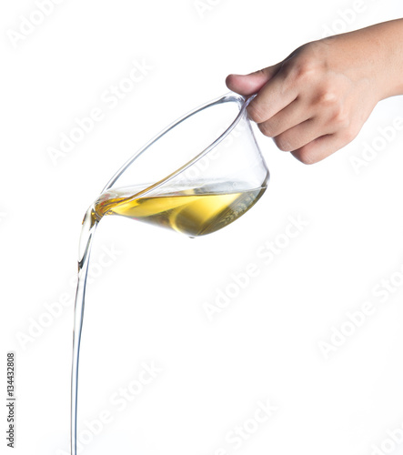 Pouring Cooking Oil From Measuring Cup Isolated On White Stock Photo 