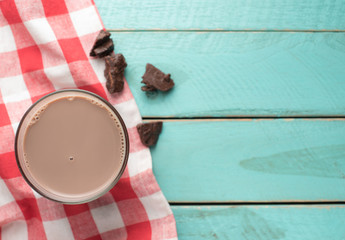 Sticker - Glass of chocolate milk on vintage wood background,top view