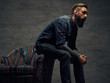 © Fxquadro - Bearded male sits on a chair.