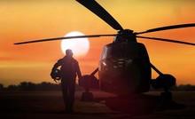 Helicopter Silhouette On The Ground During Sunset