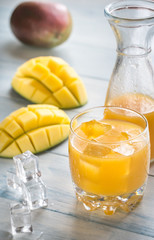 Poster - Mango juice on the wooden table