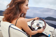 © ZoomTeam - Summer vacation - young woman driving a motor boat