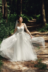  Gorgeous brunette bride posing in sunny park