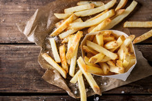 Fast Food French Fries Potatoes With Skin Served With Salt And Herbs In Lunch Box On Baking Paper Over Old Dark Wooden Background. Top View, Space For Text