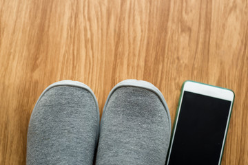 Gray sport shoes on  floor with smartphone at home. Lifestyle co