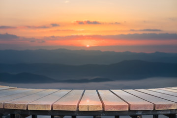 Selective foucus on Empty wooden table with the sunrise mountain view background. For display or montage your products.