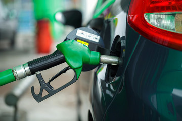 Car refueling on a petrol station in winter close up