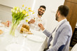 © BGStock72 - Two young men have dinner and toasting white wine