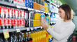 © JackF - Woman choosing refreshing beverages in supermarket