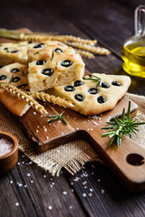 Wall Mural - Traditional Italian Focaccia with black olives and rosemary