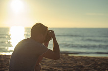 Silhouette Of Young Photographer On The Beach