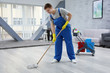 © Africa Studio - Young man with mop cleaning floor at home