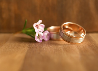 Wall Mural - Golden wedding rings on wooden background