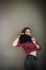 Portrait of brunette girl with cap wearing casual clothes backgr