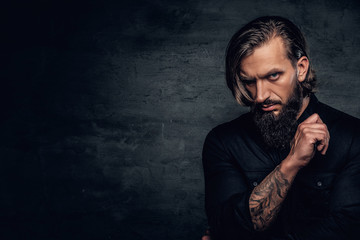 Canvas Print - A man with tattooed arm wearing black shirt.