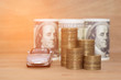 © Aleksei - buying car dollar coins stack money on wooden background