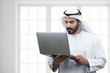 Arabian Business man using notebook in a modern office..