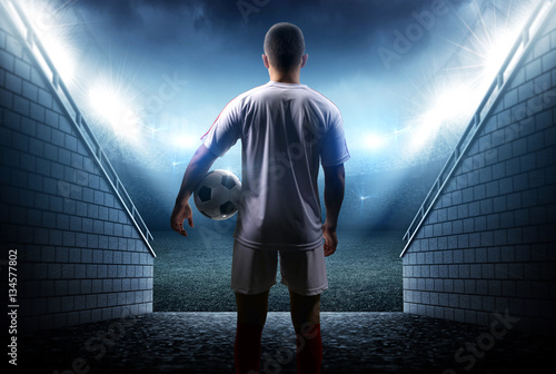 Fotografie, Obraz Football player with ball in the stadium