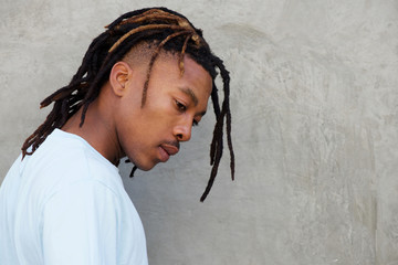 side portrait of african man with dreadlocks in contemplation