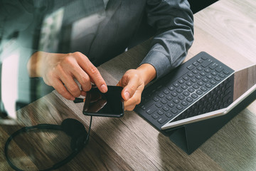 Poster - top view of man hand using VOIP headset with digital tablet comp