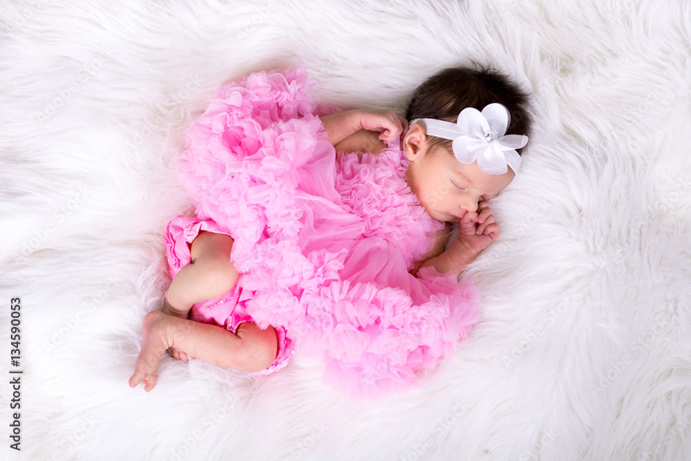 Beautiful newborn baby girl wearing a pink fluffly dress Stock Photo |  Adobe Stock