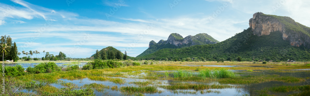 Beautiful outdoor panoramic landscape of mountains and big green lake in Sam Rai Yot region. Exotic nature photography of Thailand - obrazy, fototapety, plakaty 