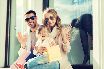 Canvas Print - happy family with child and shopping bags in city