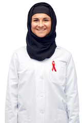 Wall Mural - muslim doctor in hijab with red awareness ribbon