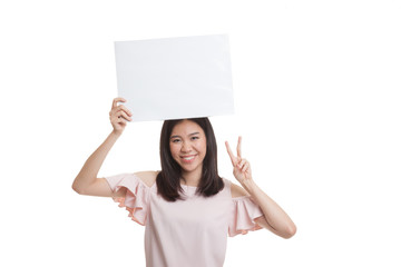 Young Asian business woman show victory sign with blank sign.