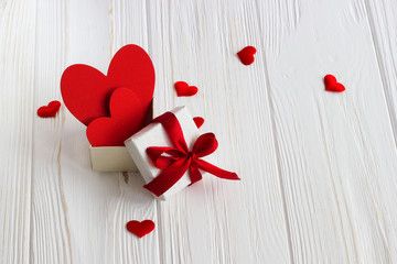 gift box with a red heart inside on a white old wooden table. Va