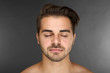 © Africa Studio - Portrait of young handsome man on grey background