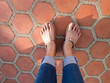 Feet selfie from upper view of a woman traveler, sandal.