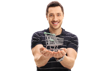 Sticker - Joyful guy holding a small empty shopping cart