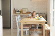 © Monkey Business - Young Girl At Home Using Digital Tablet On Kitchen Table