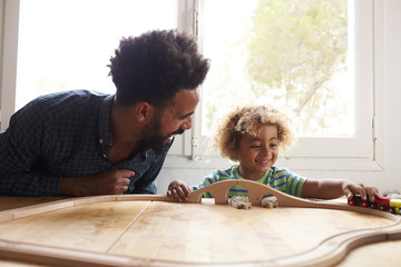 Wall Mural - Father And Son Playing With Toy Train Set