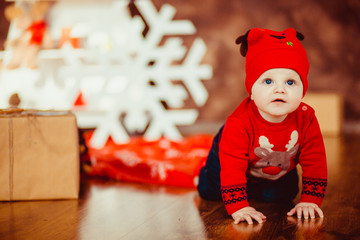 Wall Mural - Cute little boy opening Christmas presents