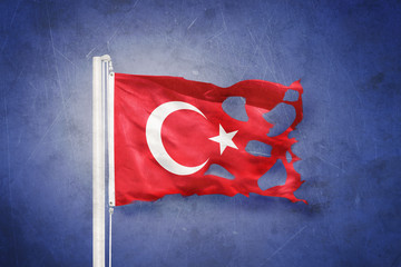 Wall Mural - Torn flag of Turkey flying against grunge background