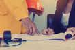 © boonchok - Engineer are described plans or drawings to colleagues or superv