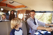 © Monkey Business - Dad driving family in a camper van, looking at his son