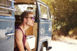 © Monkey Business - Young man sitting in the open doorway of a camper van