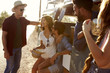 © Monkey Business - Friends on a road trip relax beside their camper van