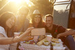 © Monkey Business - Friends taking selfie at picnic beside camper van, close up