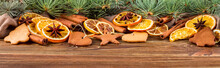Dried Oranges, Star Anise, Cinnamon Sticks And Gingerbread On A Wooden Background -- Christmas Still Life Background, Banner