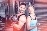 Couple posing with dumbbells