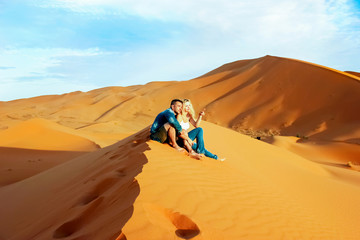 Loving couple in the Sahara Desert. Morocco.