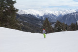 Fototapeta Natura - Snowboarder riding over the slope at the mountains.